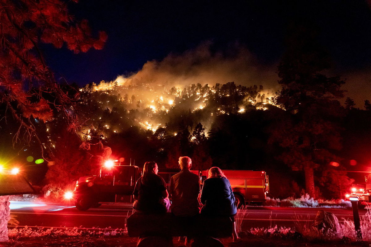 Residents watch part of the Sheep Fire burn through a hillside near their homes in Wrightwood, California, on June 11, 2022.