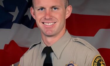 People gather Sunday at a vigil for Los Angeles County Sheriff's Deputy Ryan Clinkunbroomer at the Palmdale Sheriff's Station.