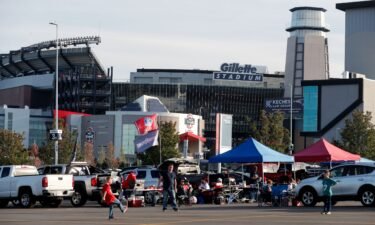 People tailgate outside Gillette Stadium before an NFL game between the New England Patriots and the Miami Dolphins on September 17.