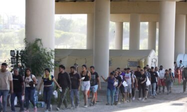 Border Patrol agents process hundreds of migrants September 20 under the International Bridge II in Eagle Pass