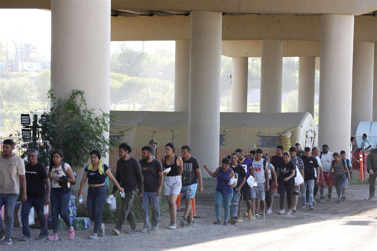<i>Jerry Lara/San Antonio Express-News/AP</i><br/>Border Patrol agents process hundreds of migrants September 20 under the International Bridge II in Eagle Pass
