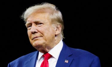 Former President and Republican presidential candidate Donald Trump looks on at a South Dakota Republican party rally in Rapid City