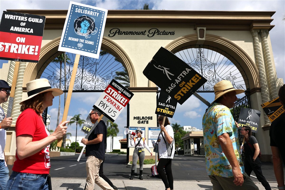 <i>Mario Tama/Getty Images</i><br/>WGA members picket with striking SAG-AFTRA members outside Paramount Studios in September.