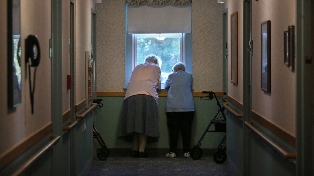 Sr. Jeanne Fregeau, 93, left and Sr. Gloria Cote, 92, talk outside their rooms at St. Chretienne Retirement Residence, a home for Catholic nuns in Marlborough, Massachusetts.