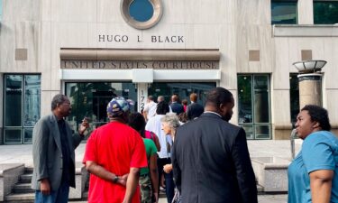 A line of people wait outside the federal courthouse in Birmingham