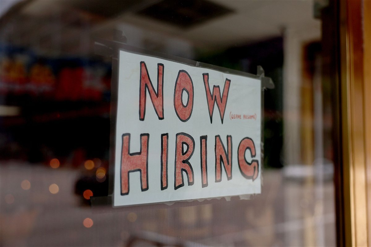 A 'Now Hiring' sign posted on the window of a business looking to hire workers on May 05, in Miami, Florida.