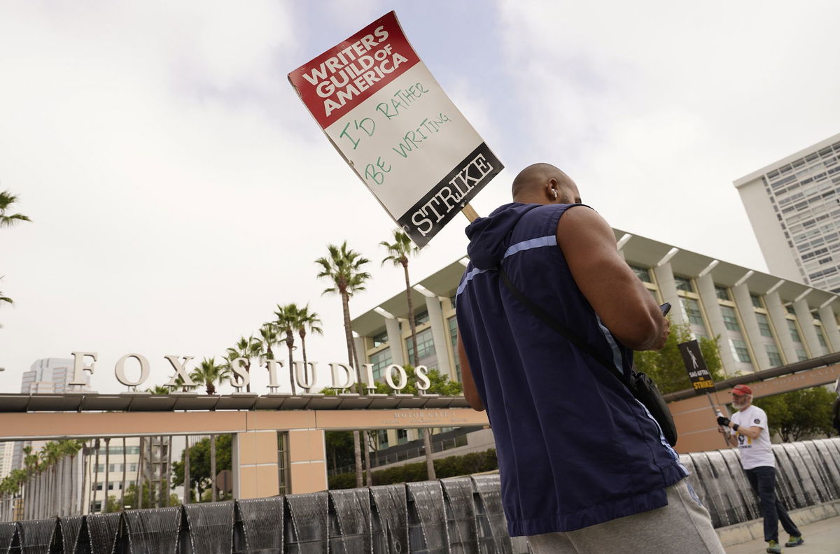 Picketers carry signs outside Fox studios on August 14 in Los Angeles. Writers and heads of the four major studios are set to meet for a second consecutive day on September 21.