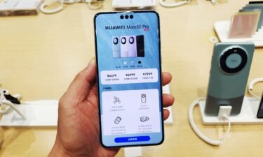 Customers experience the newly released Huawei Mate 60 Pro flagship phone at Huawei's flagship store in Shanghai