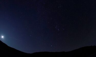 A meteor of the Orionid meteor shower streaks across the night sky above the San Rafael Swell outside Green River