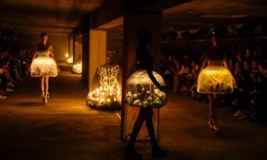 Eerily romantic terrarium dresses featuring live butterflies at the Undercover show —  a standout moment of fashion innovation.