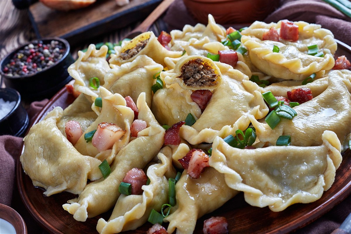 Nearly any filling will be delicious when making pierogies. Here are some with ground meat and liver filling, sprinkled with spring onion, bacon and sour cream.