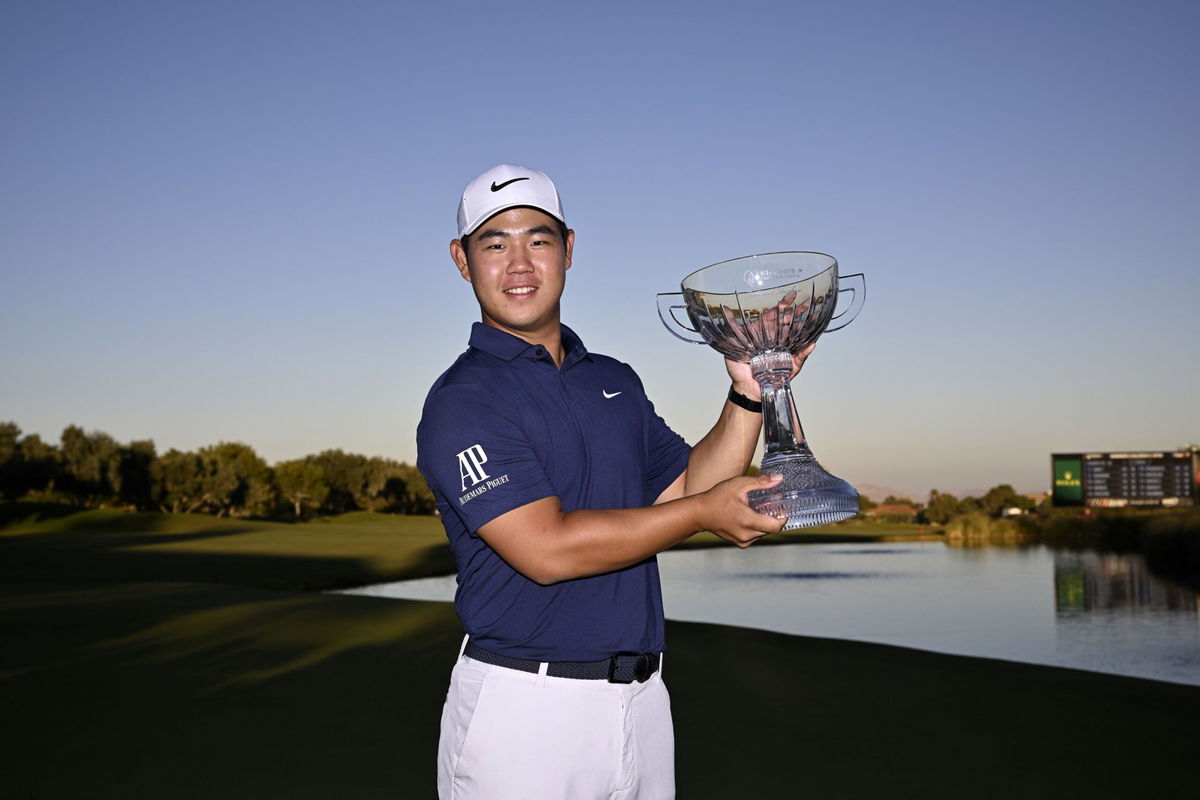 <i>Orlando Ramirez/Getty Images</i><br/>Kim toasts his win on the 18th green.