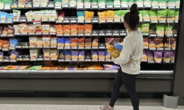 A shopper peruses cheese offerings at a Target store on October 4 in Sheridan