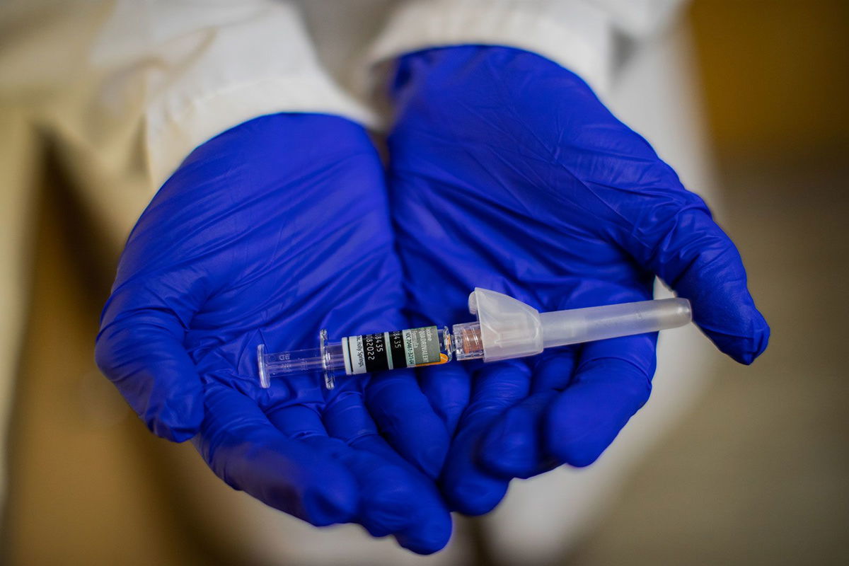 CVS MinuteClinic family nurse practitioner Kafayat Ayodele holds a Flucelvax Quadrivalent influenza vaccine at CVS MinuteClinic in September 2021 in Houston.