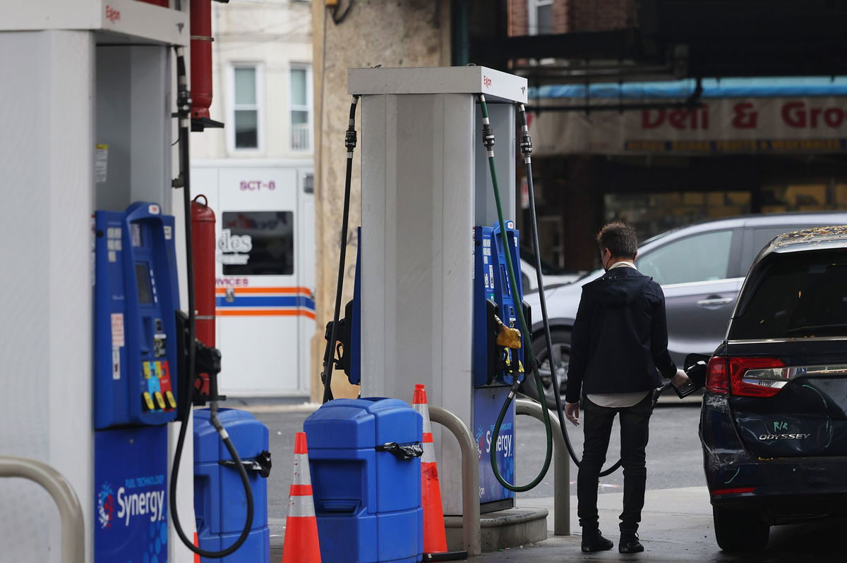 A person pumps gas at an Exxon gas station on October 06, in the Brooklyn borough of New York City.