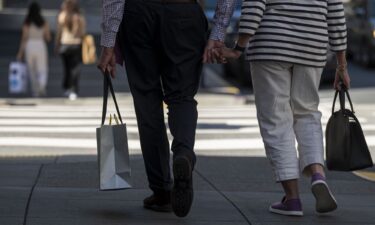 A pedestrian carries a shopping bag in San Francisco