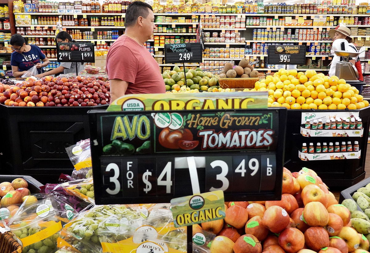 <i>Mario Tama/Getty Images</i><br/>People shop in the produce section of a grocery store on September 12