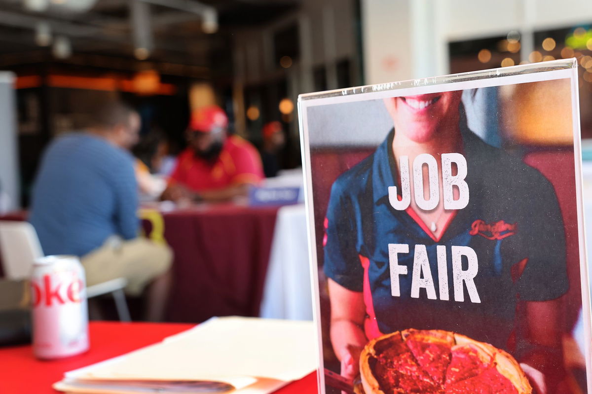 Job seekers speak with recruiters during a job fair at Navy Pier on April 11, in Chicago.