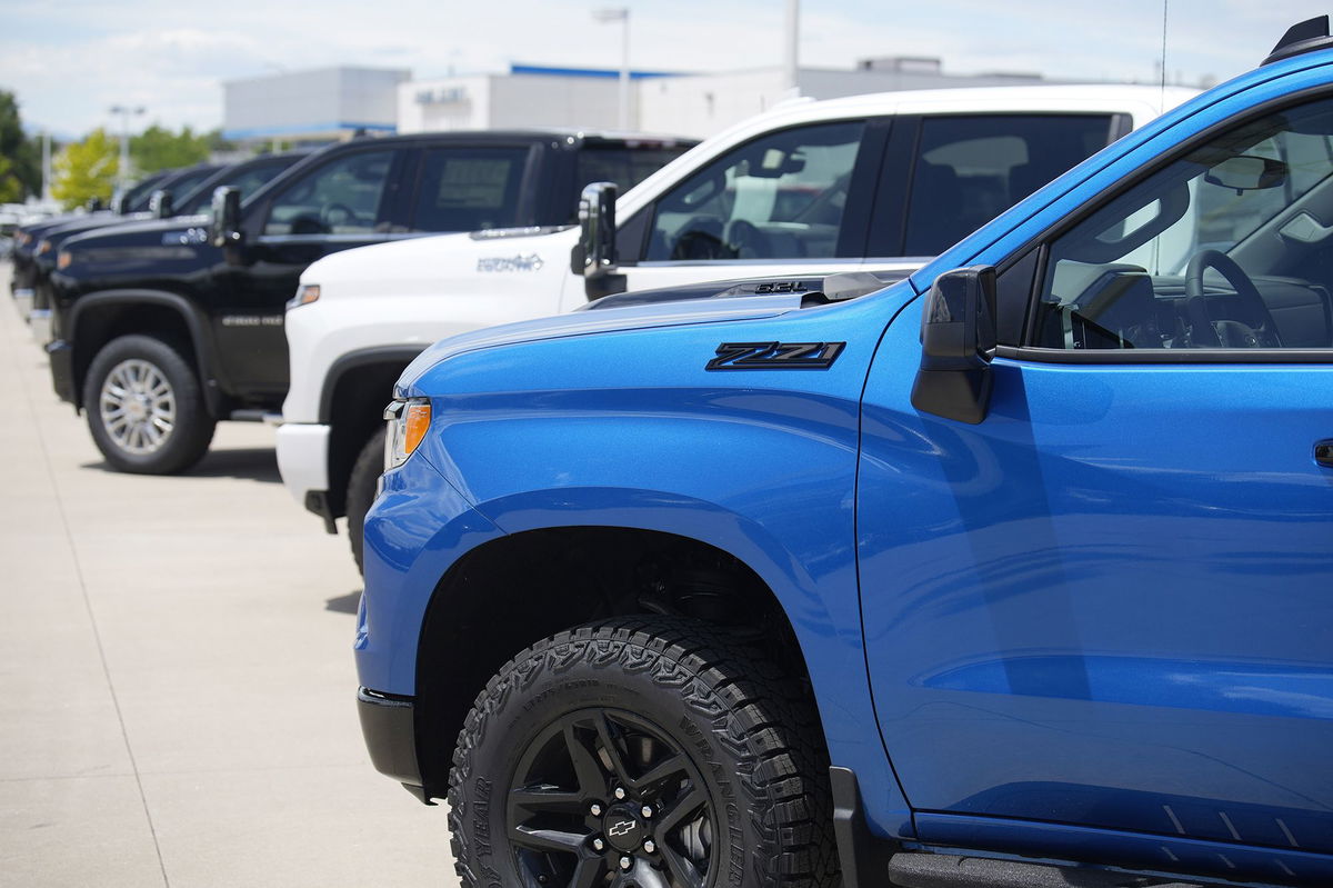 Unsold 2023 Silverado pickup trucks sit in a long row at a Chevrolet dealership Sunday, June 18, in Englewood, Colo. US new car sales soared in the third quarter, despite the combination of a strike at General Motors, Ford and Stellantis, high prices and rising interest rates.