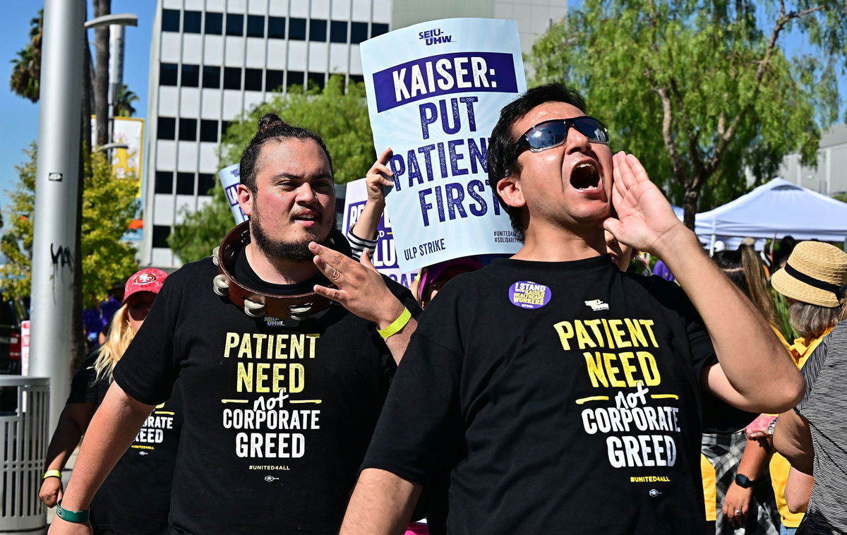 Kaiser Permanente health care employees, joined by Union members representing workers, walk the picket line in Los Angeles during the second day of their strike on October 5.