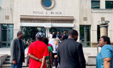 A line of people wait outside the federal courthouse in Birmingham