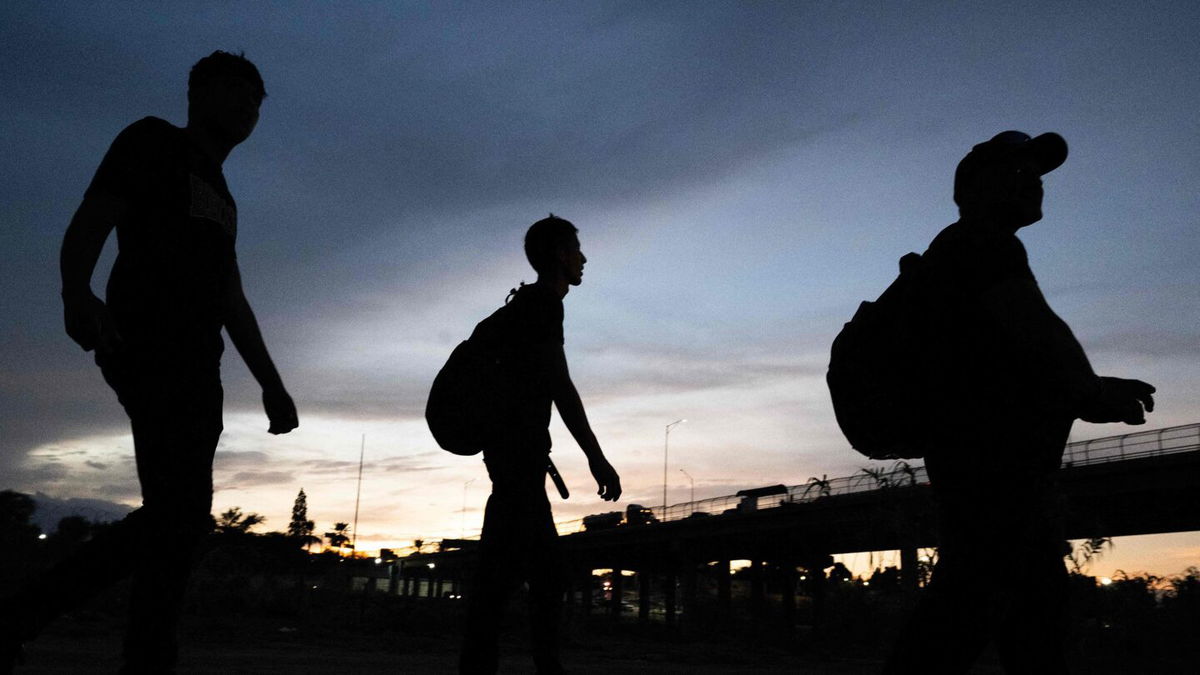 <i>Andrew Caballero-Reynolds/AFP/Getty Images</i><br/>Three migrants who walked from Venezuela arrive at a US Border Patrol processing center after they crossed the Rio Grande river and over the razor wire to cross into Eagle Pass