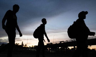 Three migrants who walked from Venezuela arrive at a US Border Patrol processing center after they crossed the Rio Grande river and over the razor wire to cross into Eagle Pass