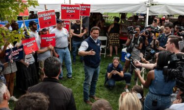 Florida Gov. Ron DeSantis speaks to reporters during an Iowa State University football game in Ames on September 9.