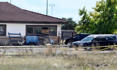 A hearse and debris can be seen at the rear of the Return to Nature Funeral Home in Penrose