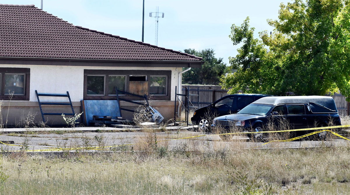 <i>Jerilee Bennett/The Gazette/AP</i><br/>A hearse and debris can be seen at the rear of the Return to Nature Funeral Home in Penrose