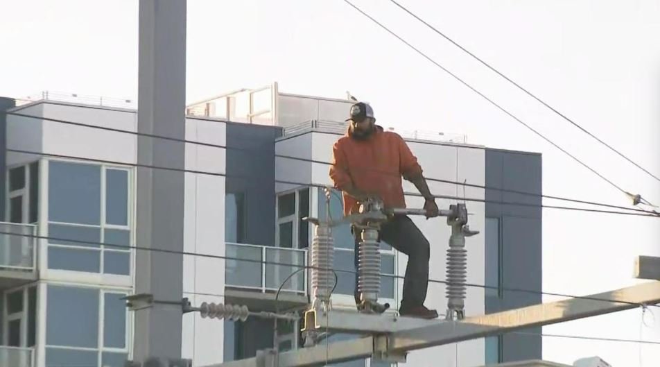 <i></i><br/>A man is seen atop a power pole apparatus above the Caltrain station platform at Fourth and King Streets in San Francisco in a hours-long standoff.