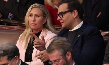 Marjorie Taylor Greene talks to George Santos in the House Chamber at the US Capitol Building on January 5