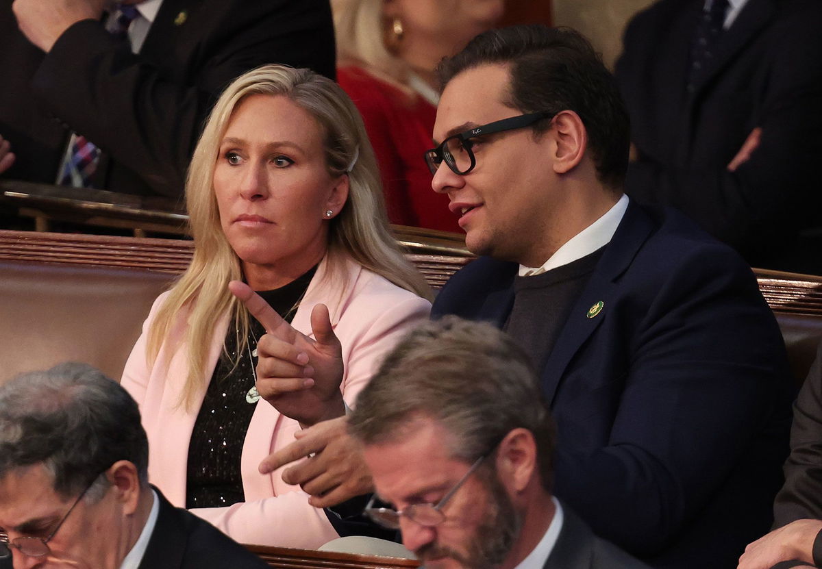 <i>Win McNamee/Getty Images</i><br/>Marjorie Taylor Greene talks to George Santos in the House Chamber at the US Capitol Building on January 5