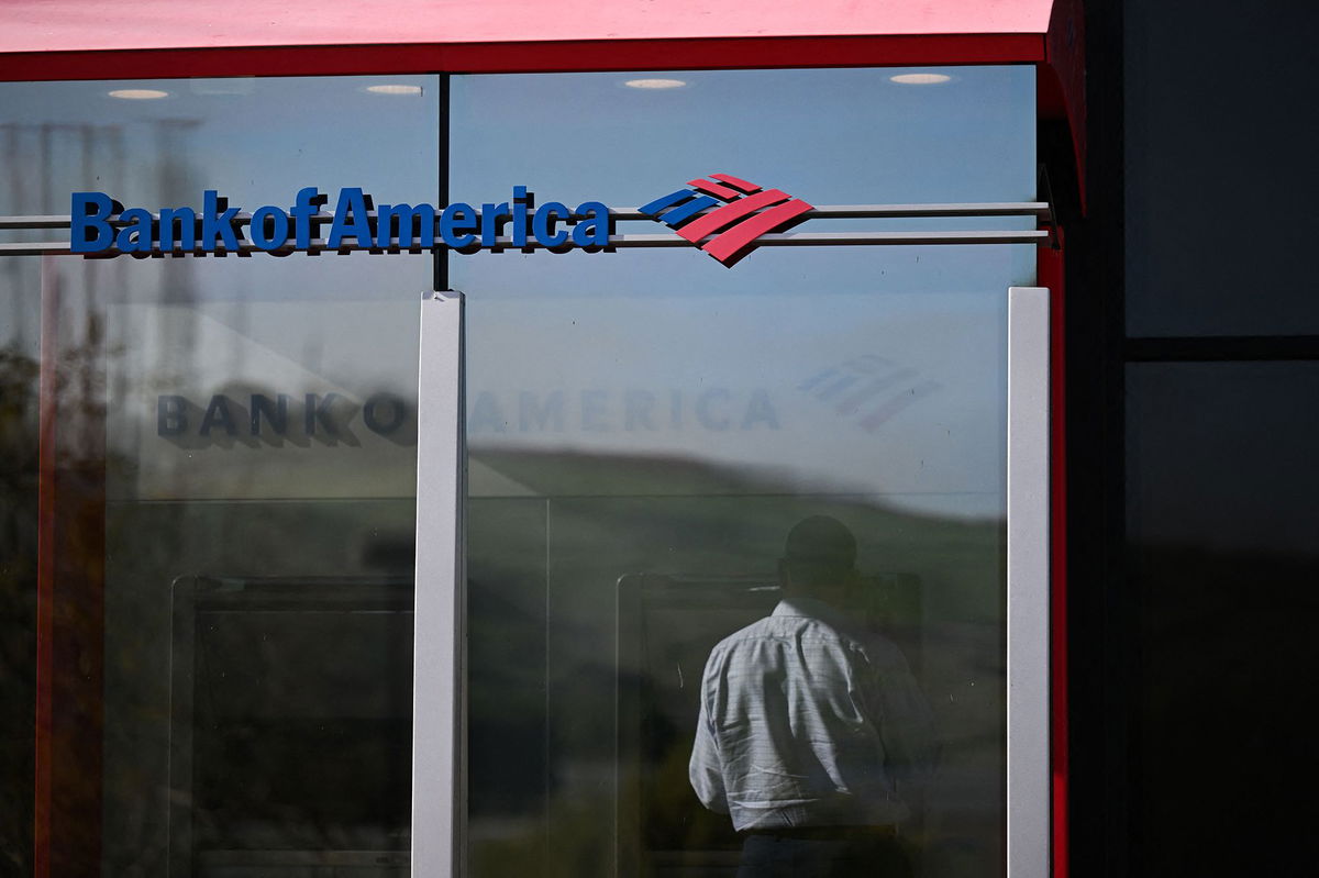 A customer uses an ATM outside of a Bank of America branch. The bank alerted customers on Friday that their deposits may be delayed due to a problem impacting multiple banks.