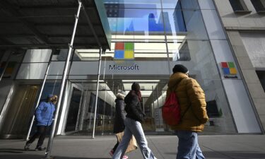 People walk past Microsoft Corp. Fifth Avenue retail store in New York