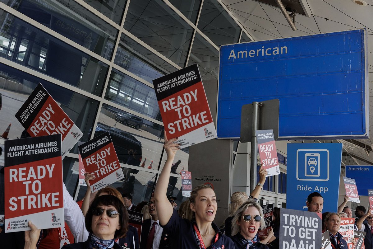 American Airlines flight attendants conduct an informational picket outside Dallas-Fort Worth International Airport on August 30. On Monday the union asked that an impasse be declared in its negotiations with the airline.