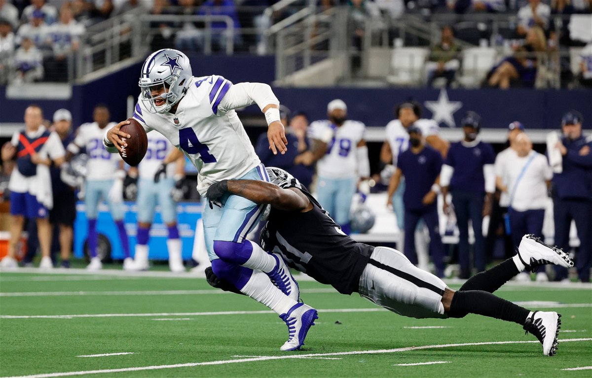 Dak Prescott of the Dallas Cowboys is tackled by Yannick Ngakoue of the Las Vegas Raiders during the fourth quarter of the Las Vegas Raiders and Dallas Cowboys game on Thanksgiving in 2021.