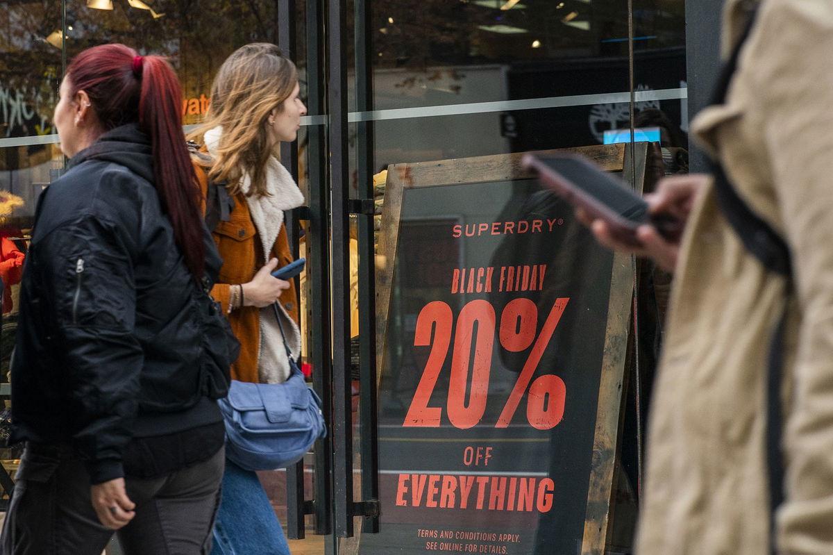 People walk near a store in preparation for Black Friday on November 17, in New York City.