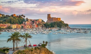 The village of Lerici on the Ligurian Coast of Italy with a colorful sunset sky.
