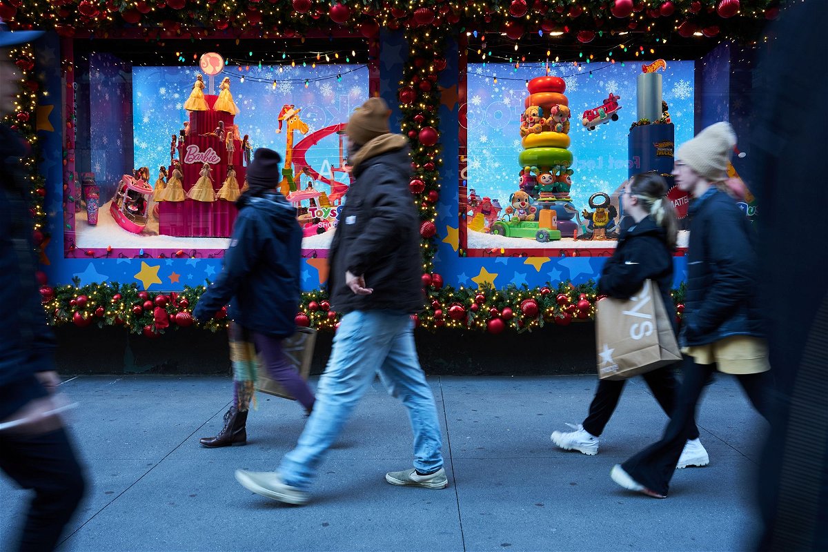 Macy's will be closed on Thanksgiving Day. Shoppers walk past holiday window displays at the Macy's Inc. flagship store in the Herald Square area of New York, on November 13.