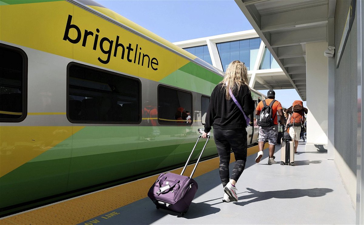 Passengers load a Brightline train to West Palm Beach at the Fort Lauderdale station on Feb. 27, in Florida and the privately owned high-speed rail network plans a Los Angeles to Las Vegas route.