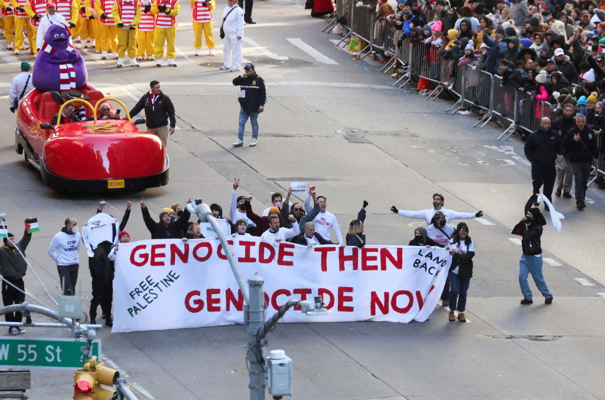 <i>Brendan McDermid/Reuters</i><br/>Pro-Palestinian protesters demonstrate during the 97th Macy's Thanksgiving Day Parade in New York City Thursday.