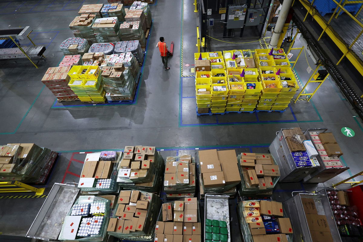 A worker stands amid stacks of products during Cyber Monday at the Amazon's fulfillment center in Robbinsville, New Jersey, November 27.