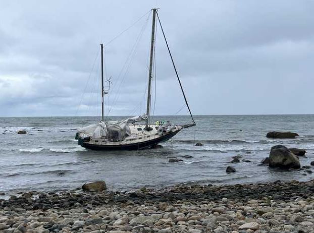 <i></i><br/>Firefighters helped two men and a woman back to shore after the sailboat they were on ran aground off the coast of Massachusetts.