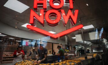 Krispy Kreme workers prepare donuts in the firm's first store in France on December 4.