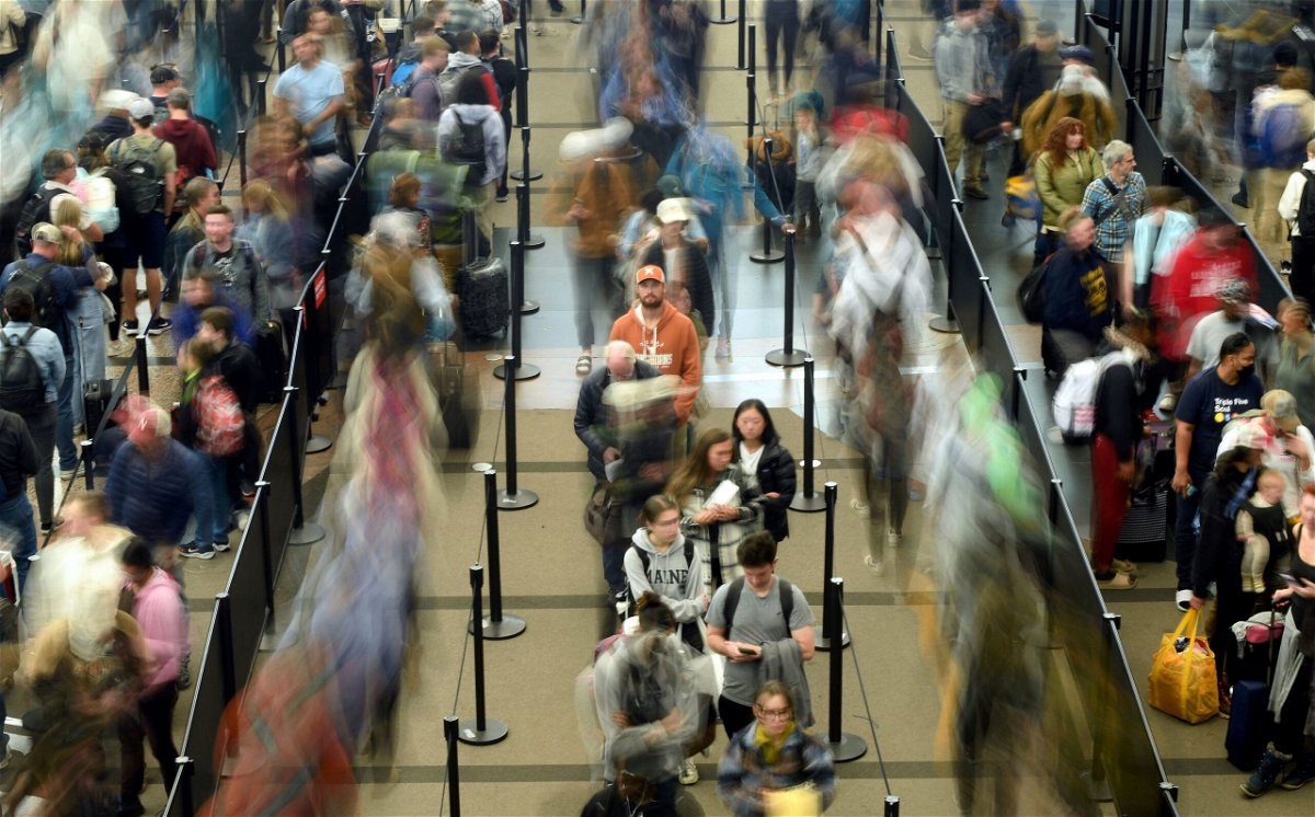 Travelers waiting in a security line at Denver International Airport on November 21 are captured in this long-exposure photo.