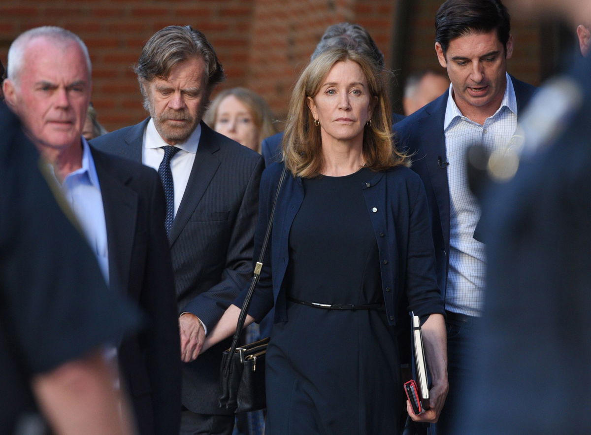 <i>Faith Ninivaggi/Boston Herald/Media News Group/Getty Images</i><br/>Felicity Huffman leaves court after being sentenced in September 2019.