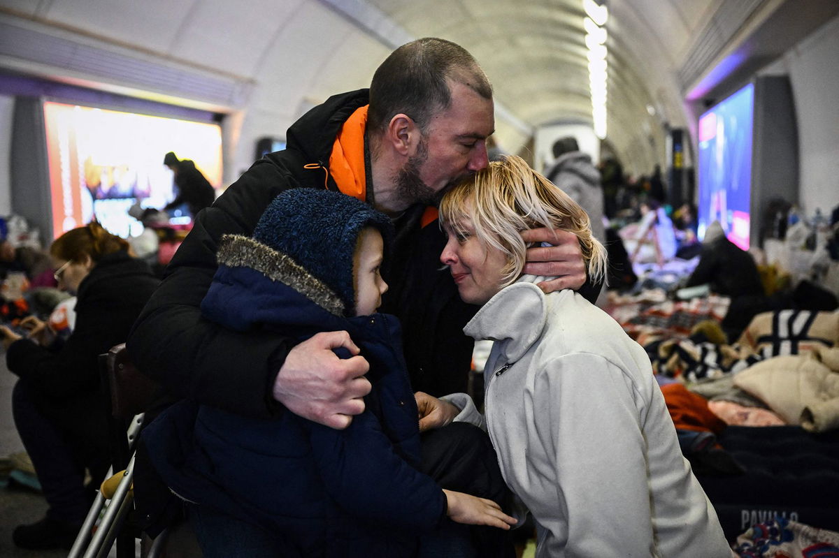 A family takes refuge in a metro station serving as a bomb shelter in Kyiv.