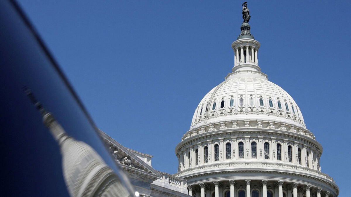 <i>Amanda Andrade-Rhoades/Reuters</i><br/>The dome of the US Capitol is reflected in a window on Capitol Hill in Washington