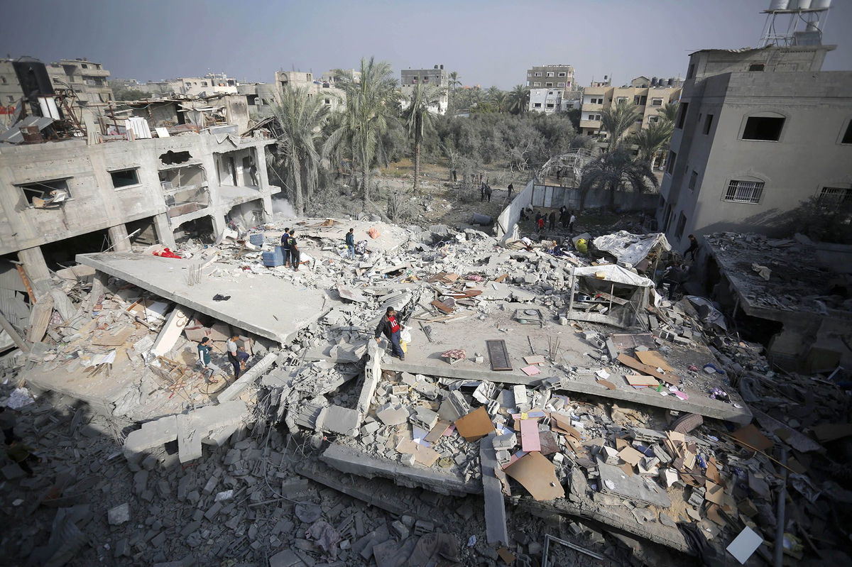 <i>Ashraf Amra/Anadolu/Getty Images</i><br/>An aerial view of a destroyed residential area as Palestinians try to collect usable items under the rubbles of a building